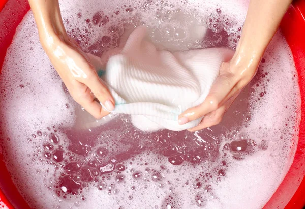 Women washing white sweater clothes in basin enemale powdered detergent — Stock Photo, Image