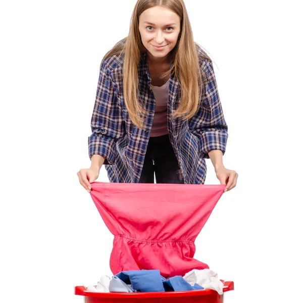 Beautiful young woman is holding a basin with laundry smiling — Stock Photo, Image