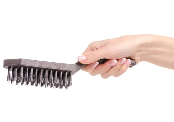 Brush on metal in hand — Stock Photo, Image