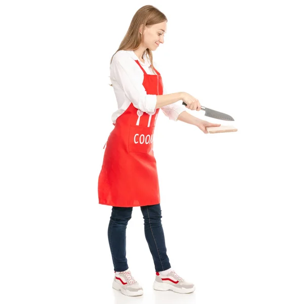 Egy nő, egy piros kötény, a kést kezébe fa vágódeszka — Stock Fotó