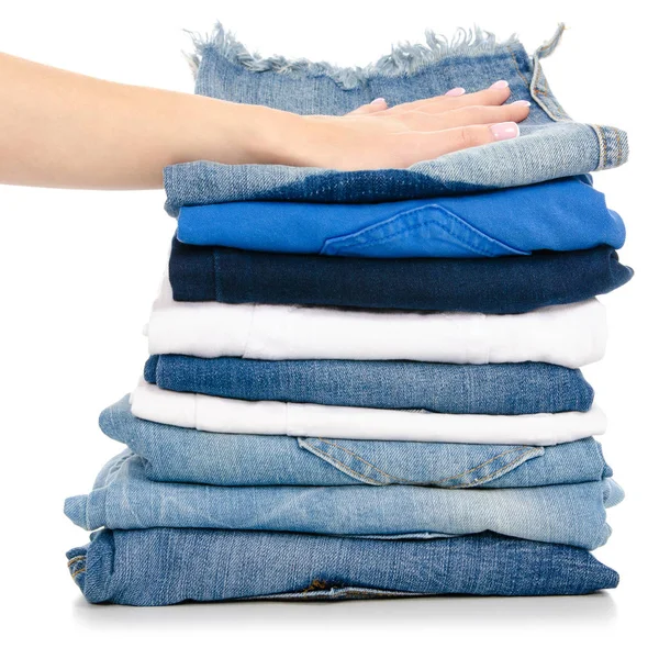 En stack av kläder jeans kvinnlig hand — Stockfoto