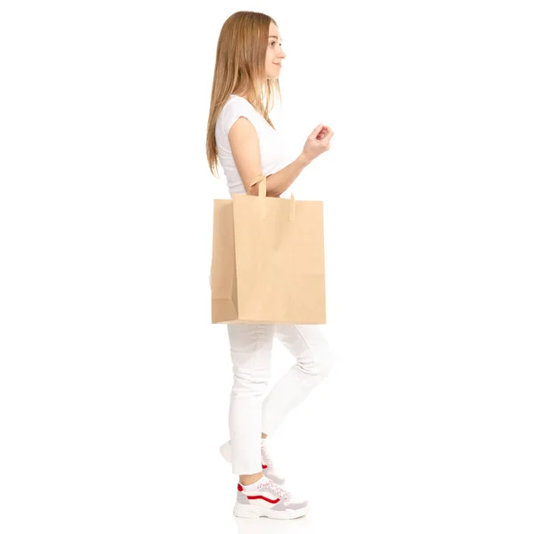 Beautiful woman in white t-shirt and jeans in hand package bag — Stock Photo, Image