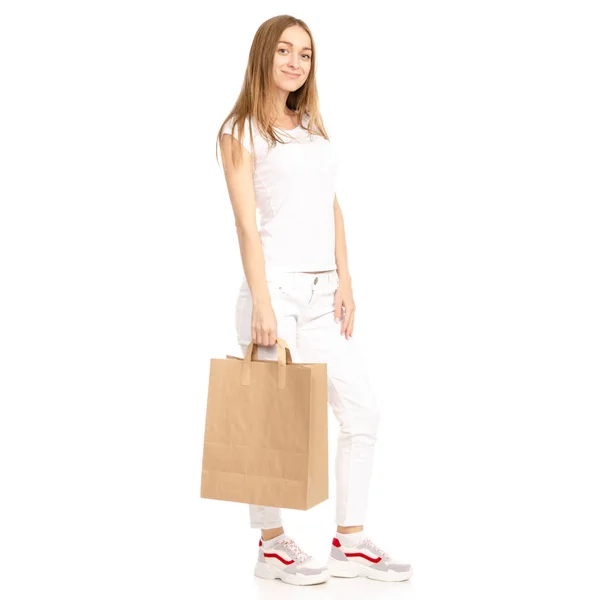 Mulher bonita em t-shirt branca e jeans em saco de pacote de mão — Fotografia de Stock