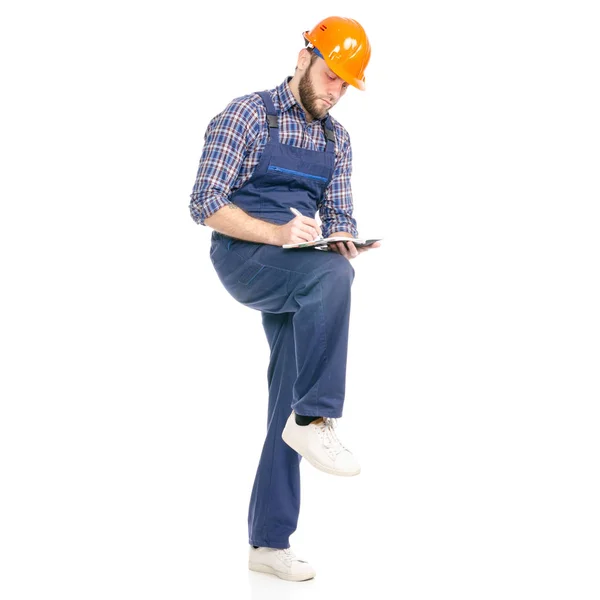 Young man builder industry worker hardhat  with a notebook and pen in hand — Stock Photo, Image