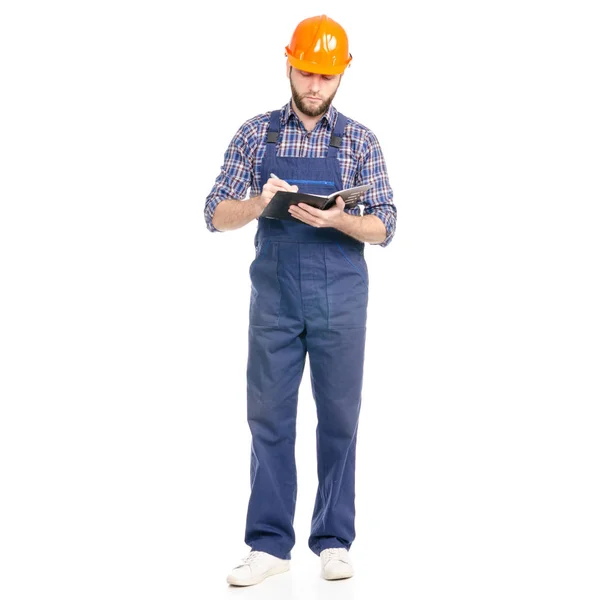 Jovem homem construtor indústria trabalhador hardhat com um caderno e caneta na mão — Fotografia de Stock