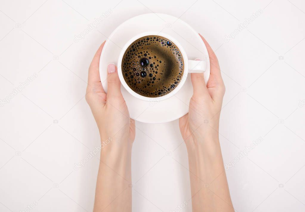 The cup of coffee in hand on white background