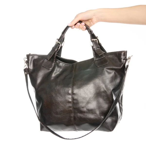 Kvinnans kvinnliga svart brunt läder väska i handen — Stockfoto