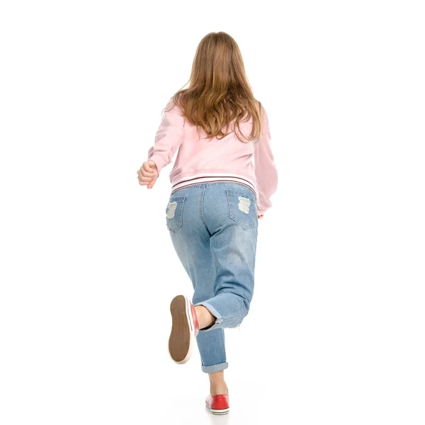 Beautiful woman in jeans jumping happy goes runs — Stock Photo, Image