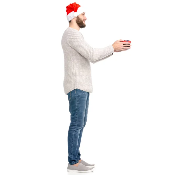 A man in jeans sweater with Santa hat showing of positive emotions happy with box gift in hand — Stock Photo, Image