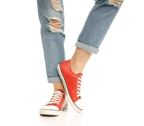 Woman legs feet jeans red sneakers hipster style — Stock Photo, Image