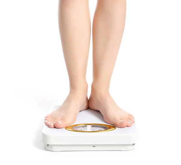 Vrouwelijke voeten met een gewicht van schaal — Stockfoto