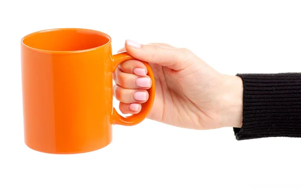 Orange cup mug in female hand — Stock Photo, Image