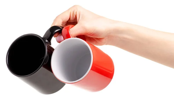 Dois copos caneca vermelho preto na mão — Fotografia de Stock