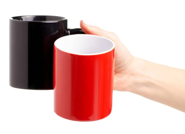 Dos tazas taza roja negra en la mano — Foto de Stock