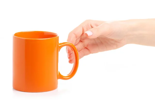 Orange cup mug in female hand — Stock Photo, Image