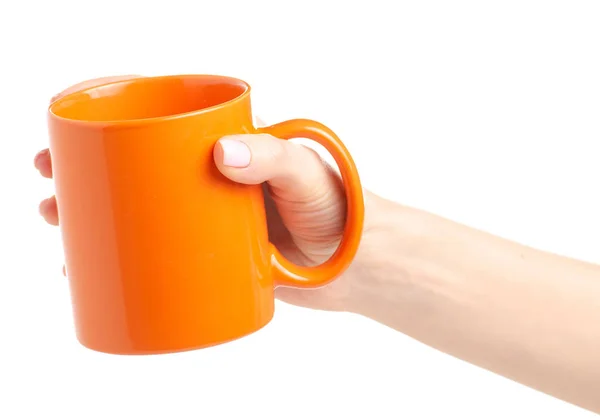 Orange cup mug in female hand — Stock Photo, Image