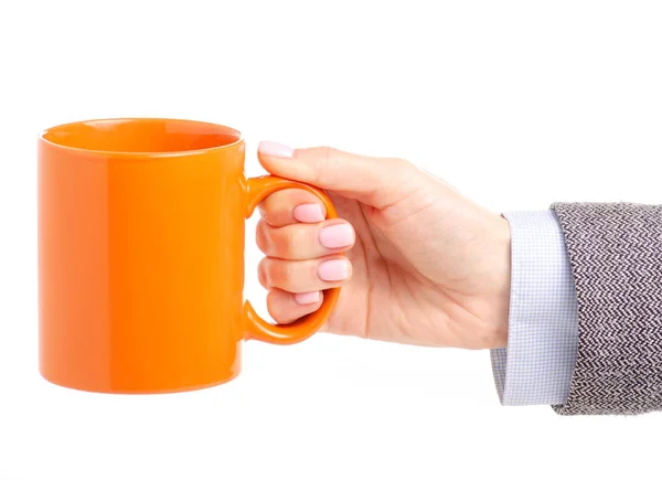 Caneca copo laranja na mão feminina — Fotografia de Stock