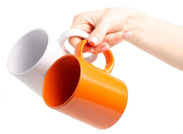 Két csésze bögre fehér narancs a kezében — Stock Fotó