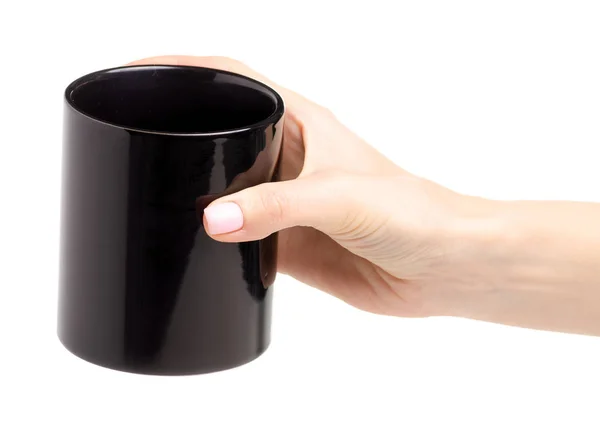 Black cup mug in female hand — Stock Photo, Image