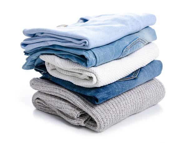 Stack of clothing jeans sweaters — Stock Photo, Image