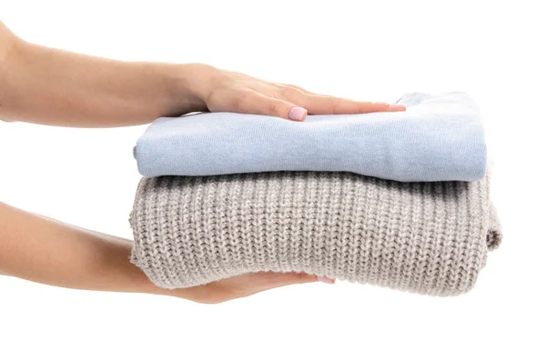 Pila de suéteres plegados en la mano — Foto de Stock