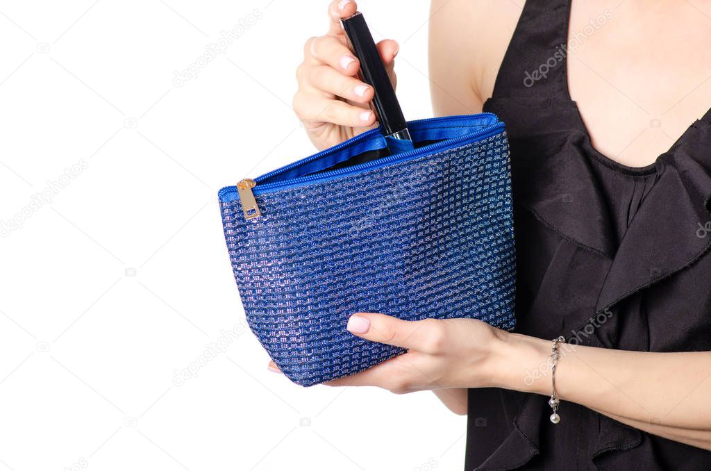 Woman holding blue cosmetic bag
