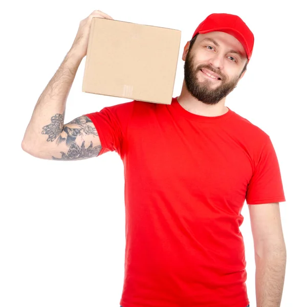 Delivery man in red uniform holding box package — Stock Photo, Image