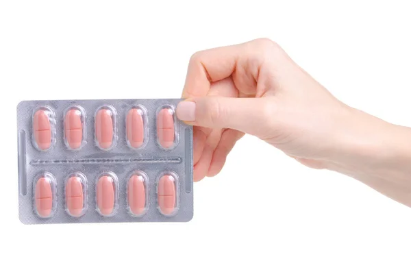 Cápsula de píldora rosa en blister en medicina de la mano salud — Foto de Stock