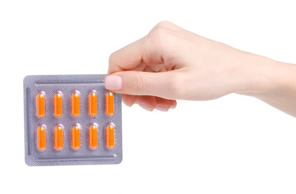 Pill capsule orange in blister in hand medicine health — Stock Photo, Image