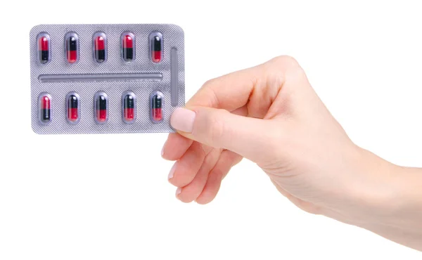 Cápsula de la píldora roja negra en blíster en medicina de la mano salud —  Fotos de Stock