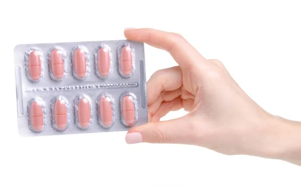 Pílula de rosa em blister na saúde medicina mão — Fotografia de Stock