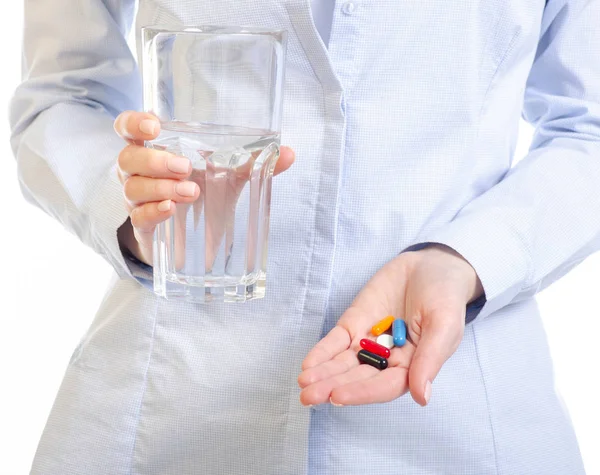 Cápsulas píldoras y vaso de agua medicina en la mano mujer —  Fotos de Stock