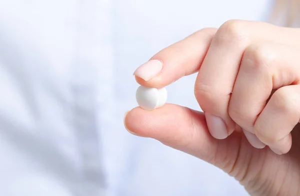 White pills medicine in woman hand Stock Image