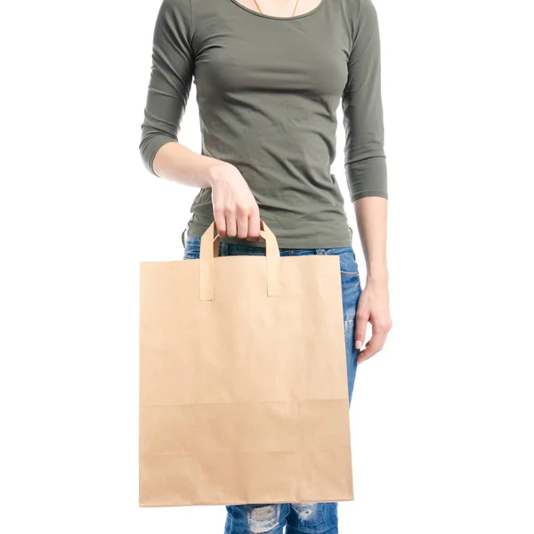 Woman in jeans and green shirt bag package in hand fashion buy sale macro — Stock Photo, Image