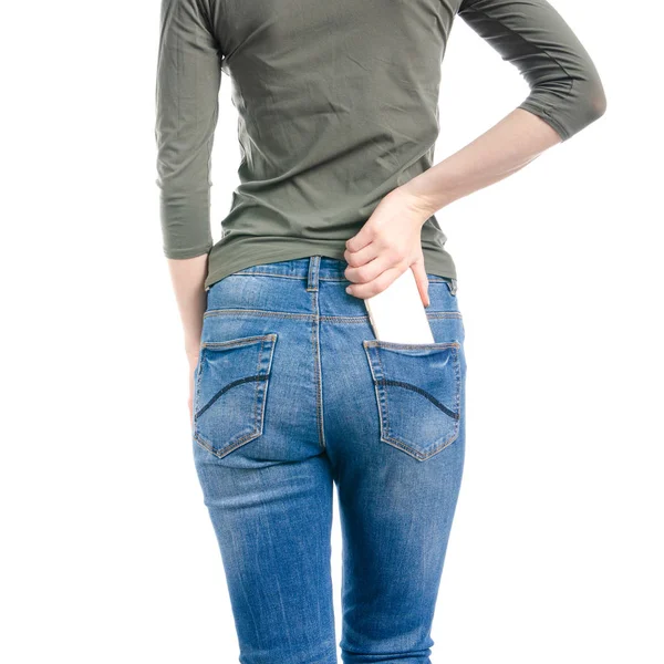 Woman in jeans and green shirt put smartphone pocket in hand macro — Stock Photo, Image