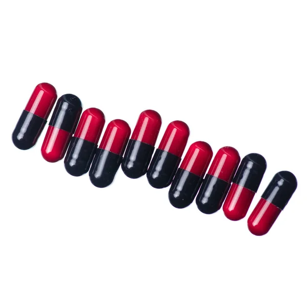 Capsule pills medicine pharmacy red black — Stock Photo, Image