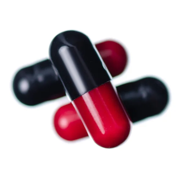 Cápsula pílulas medicina farmácia vermelho preto — Fotografia de Stock