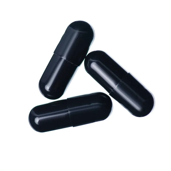 Cápsulas pastillas medicina farmacia negro — Foto de Stock