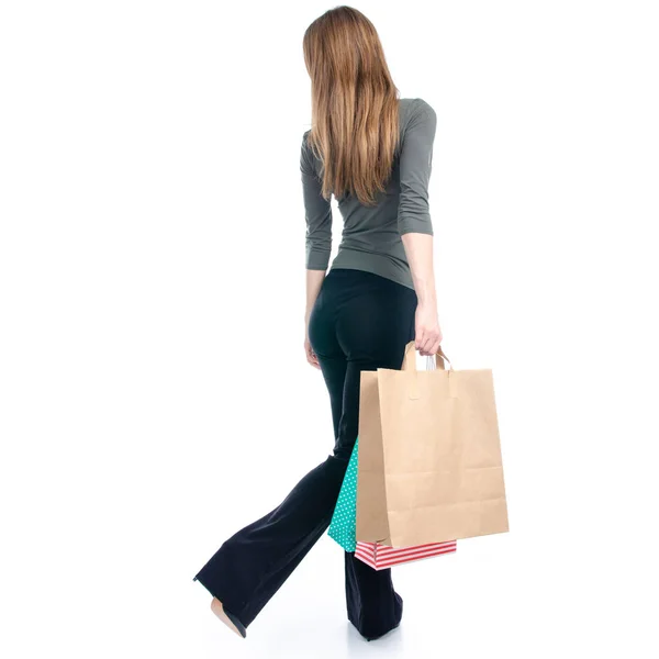 Woman in high heels shoes with bags package shopping in hand goes — Stock Photo, Image