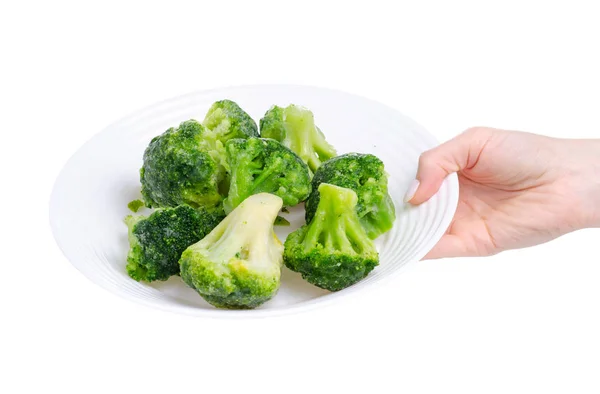 Bevroren broccoli in de plaat in de hand — Stockfoto