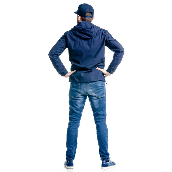 En man i jeans och jacka stående inne — Stockfoto
