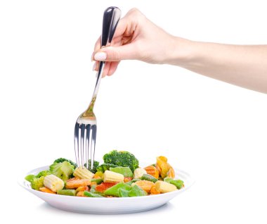 Dondurulmuş sebze tabak çatal üzerinde el