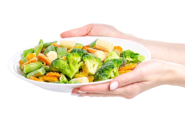 Заморожені овочі на тарілці рука тримає — стокове фото