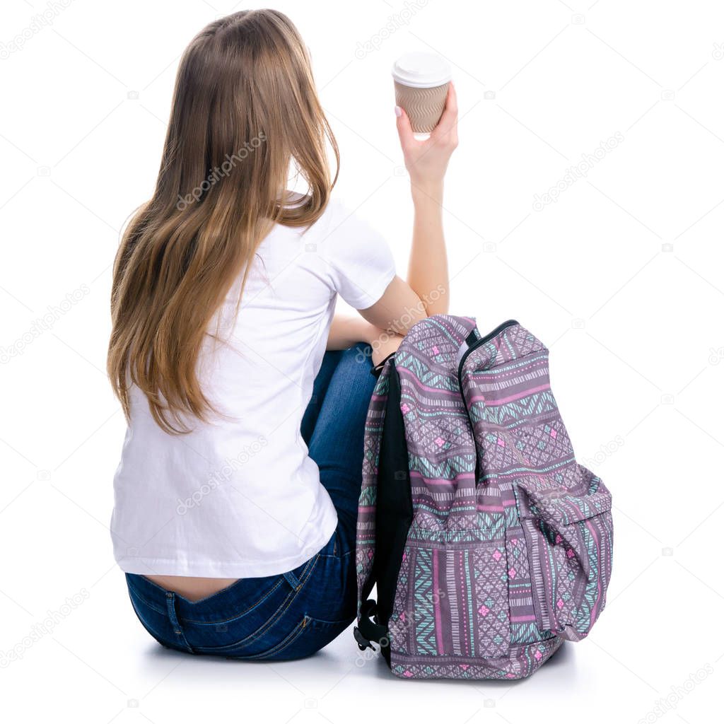 Woman sitting with backpack with cardboard cup of coffee