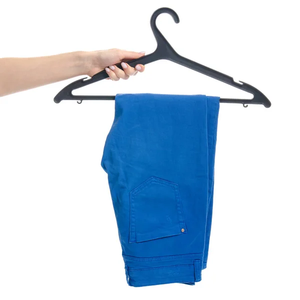 Blue jeans on hanger in hand — Stock Photo, Image