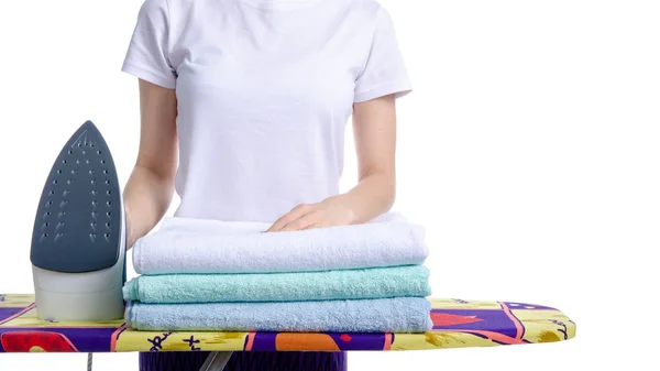 Woman ironing laundry towels on iron board — Stock Photo, Image