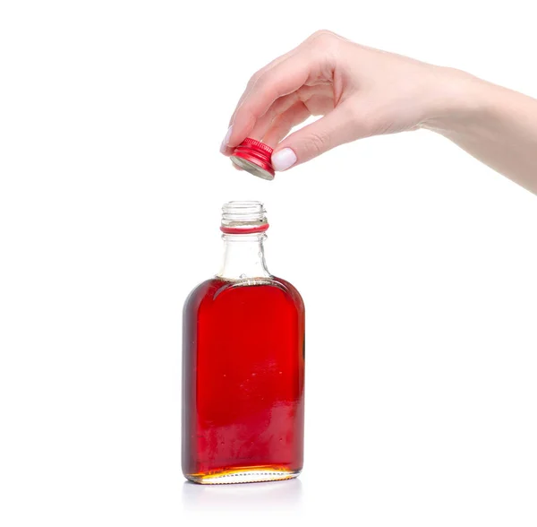 Xarope de rosácea em garrafa na mão — Fotografia de Stock