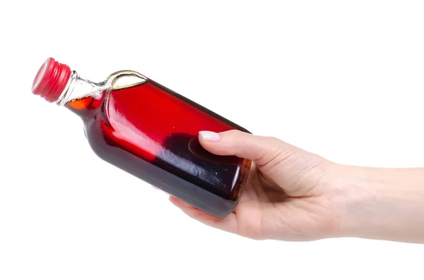 Xarope de rosácea em garrafa na mão — Fotografia de Stock