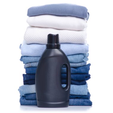 Siyah şişe sıvı çamaşır ile yığın beyaz mavi giysi ve kot pantolon