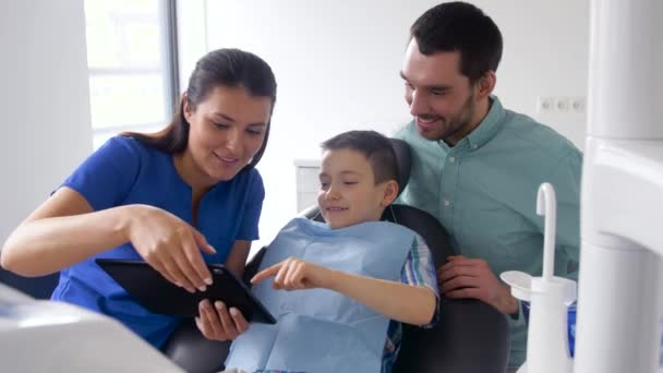 Dentista mostrando tableta pc al paciente en la clínica — Vídeos de Stock